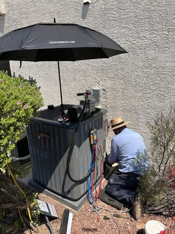 HVAC technician performing outdoor AC maintenance in Royal Palm Beach